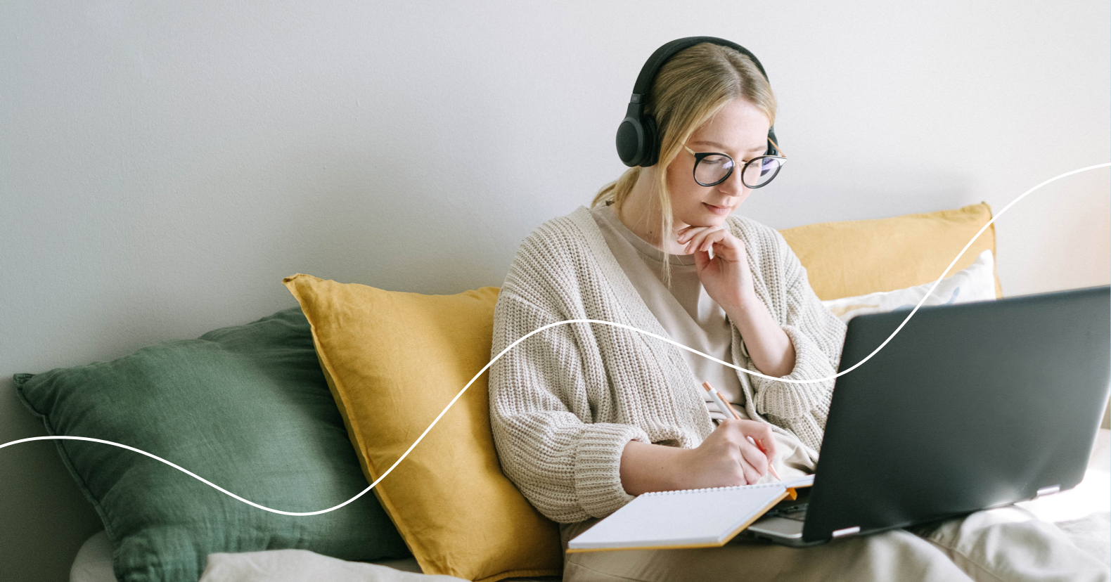 Marketing podcasts Young blonde woman working at a laptop with headphones